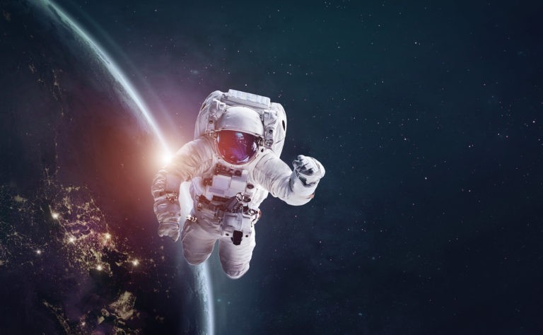 Astronaut floating in space with the Earth in the background.