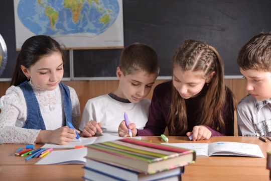 A group of young students working on an assignment together