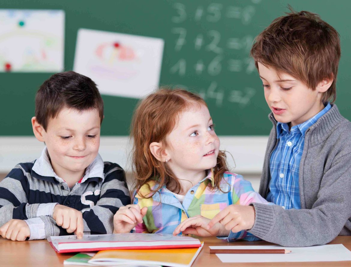 Three young students working together on math problems