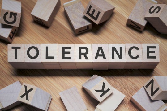 'Tolerance’ spelled out in wooden blocks.