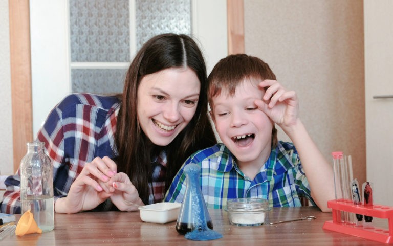 Mom and young son doing a science experiment at home.