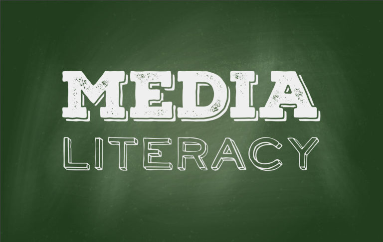 ‘Media Literacy’ drawn on a green chalkboard.