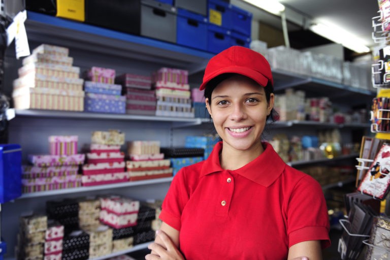 Young woman in an employee uniform at a gift shop.