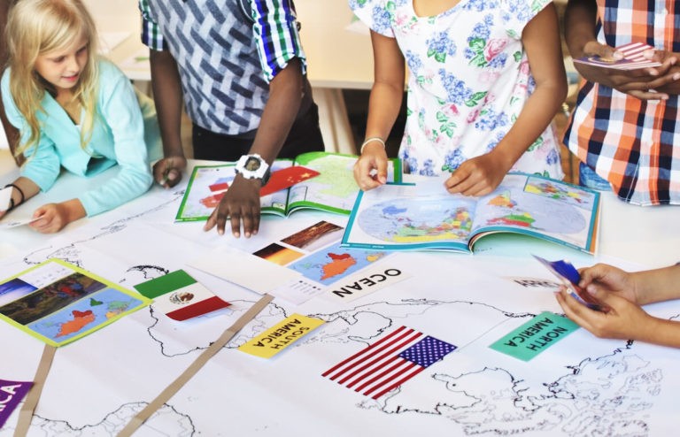 Group of young students working on a project together.