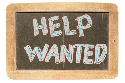 A sign written in chalk that reads “Help Wanted”