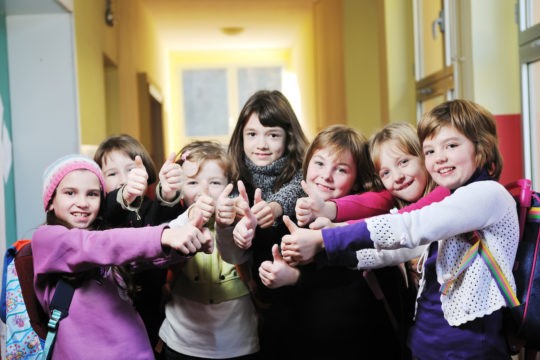 Group of students displaying the thumbs-up sign.