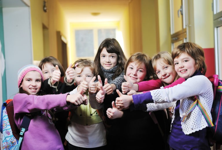 Group of students displaying the thumbs-up sign.